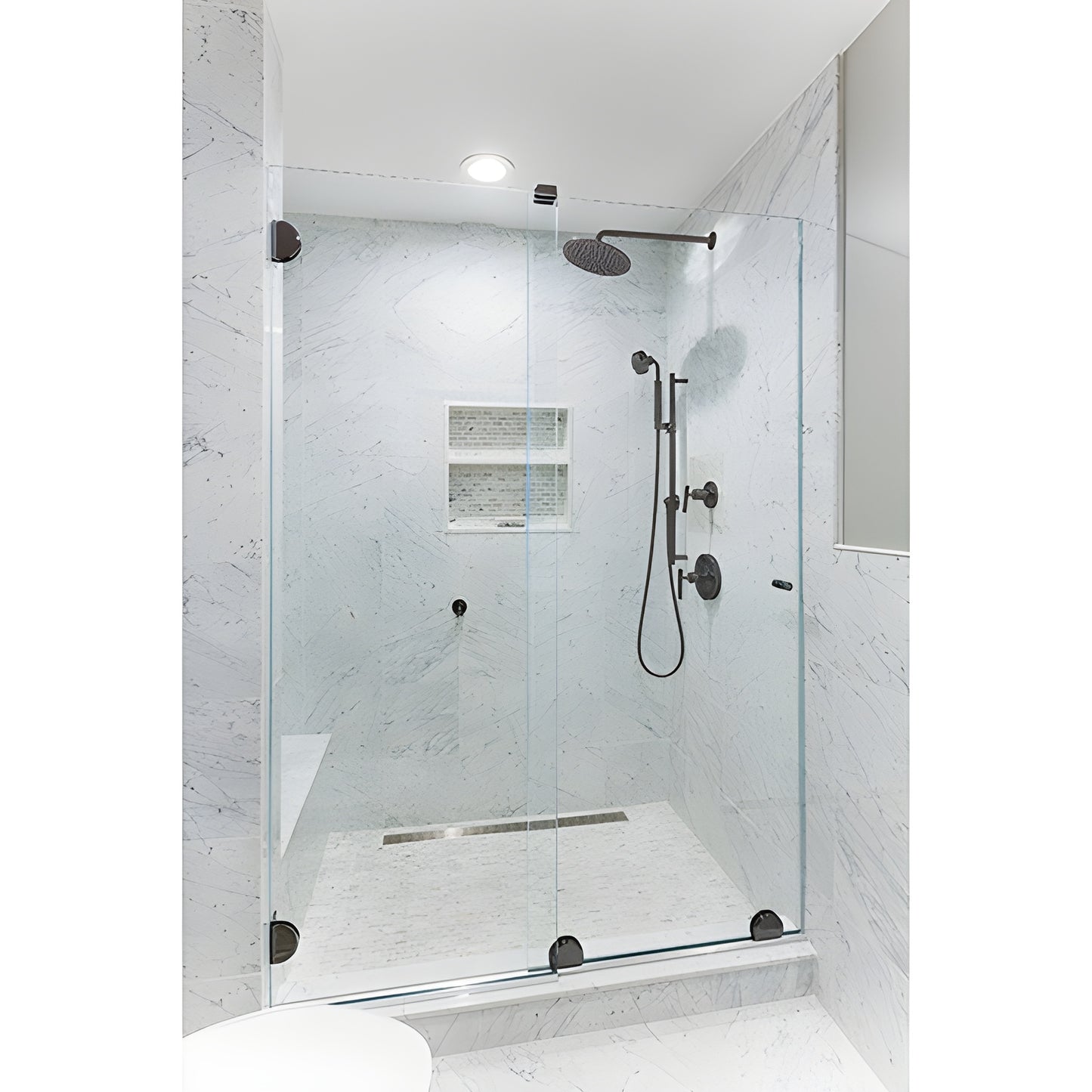 ESS10RB frameless sliding shower door kit with oil-rubbed bronze bottom rollers on clear glass in marble shower.