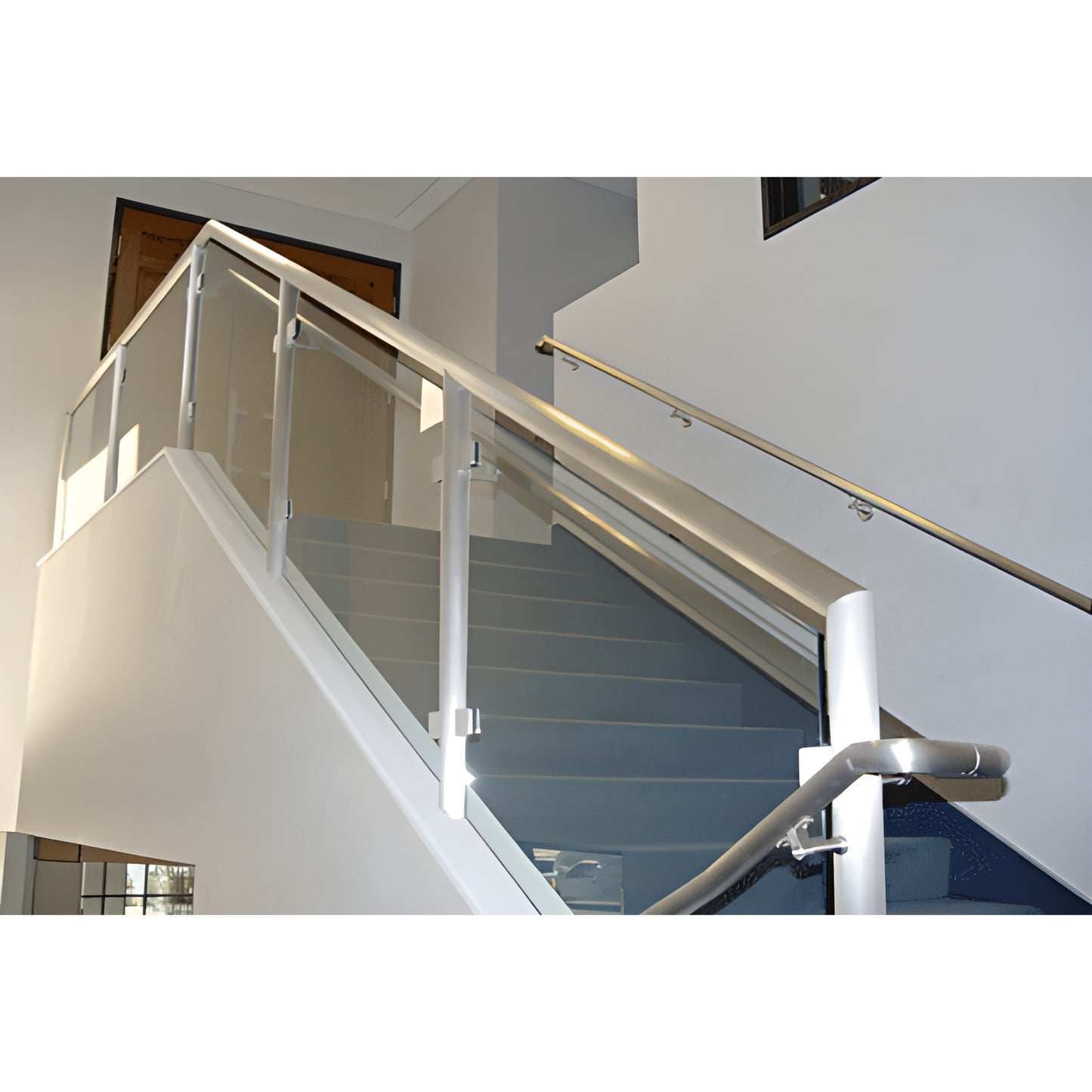PR1540M mill-finish aluminum welded stair railing with glass panels and tubular posts.