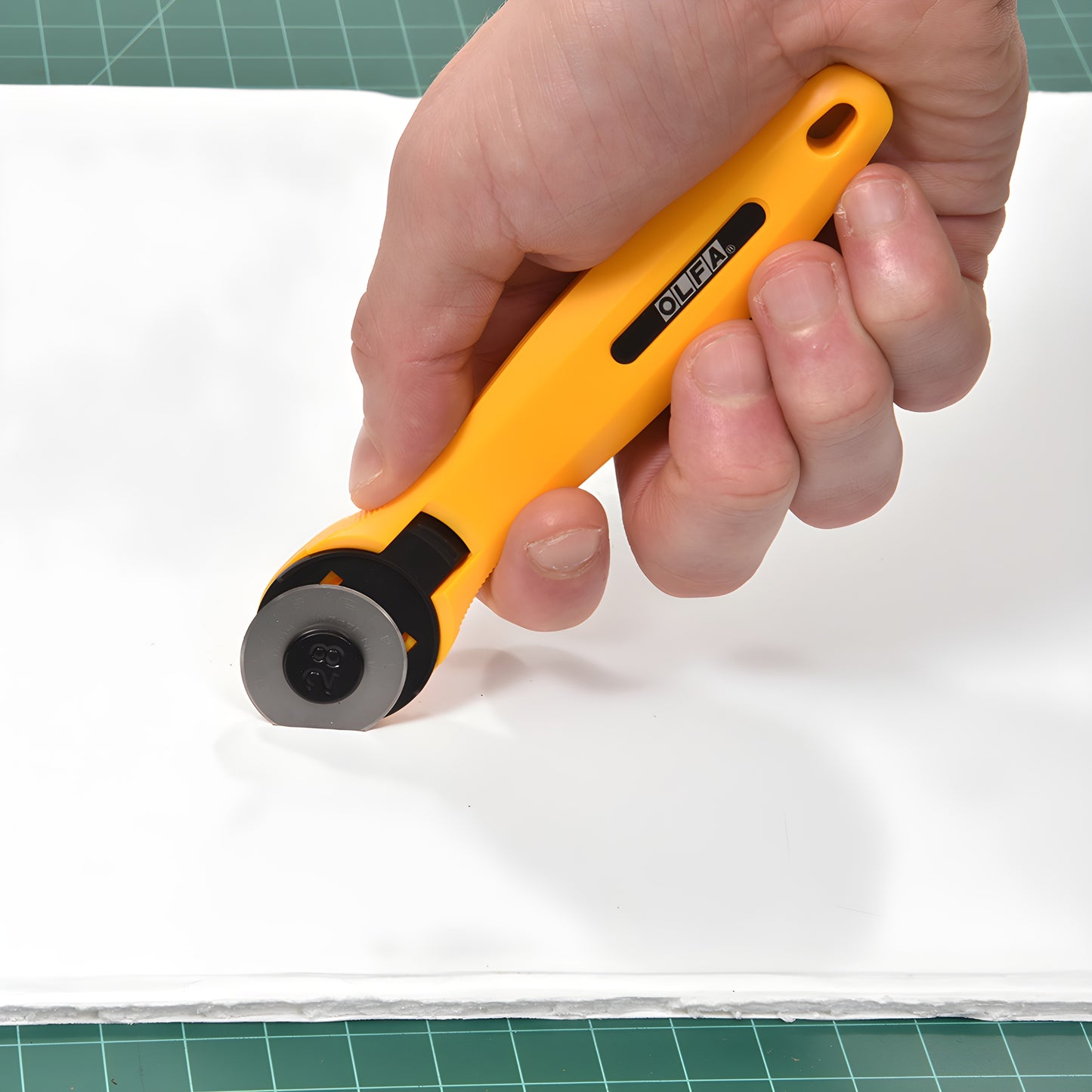 Olfa RT28 1in rotary cutter - compact orange straight handle with 28mm tungsten steel blade.