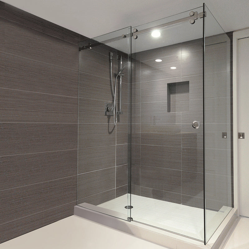 A modern walk-in shower enclosure featuring the Bristol Series sliding glass door with brushed stainless steel hardware.