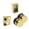A set of satin brass Brixen shower door components including two rollers, a wall bracket, and a stopper.