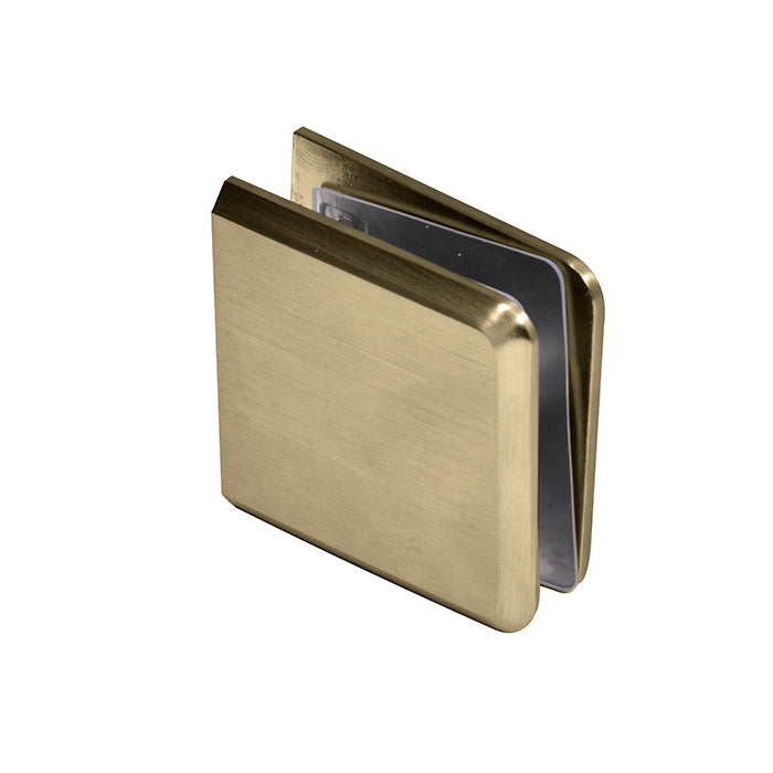 A close-up view of the brushed bronze beveled glass clamp showing its heavy-duty brass construction.