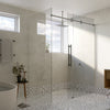 A close-up view of the brushed stainless steel Cavoli sliding shower system installed in a modern bathroom.