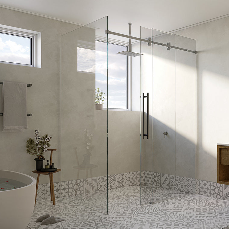 A close-up view of the brushed stainless steel Cavoli sliding shower system installed in a modern bathroom.