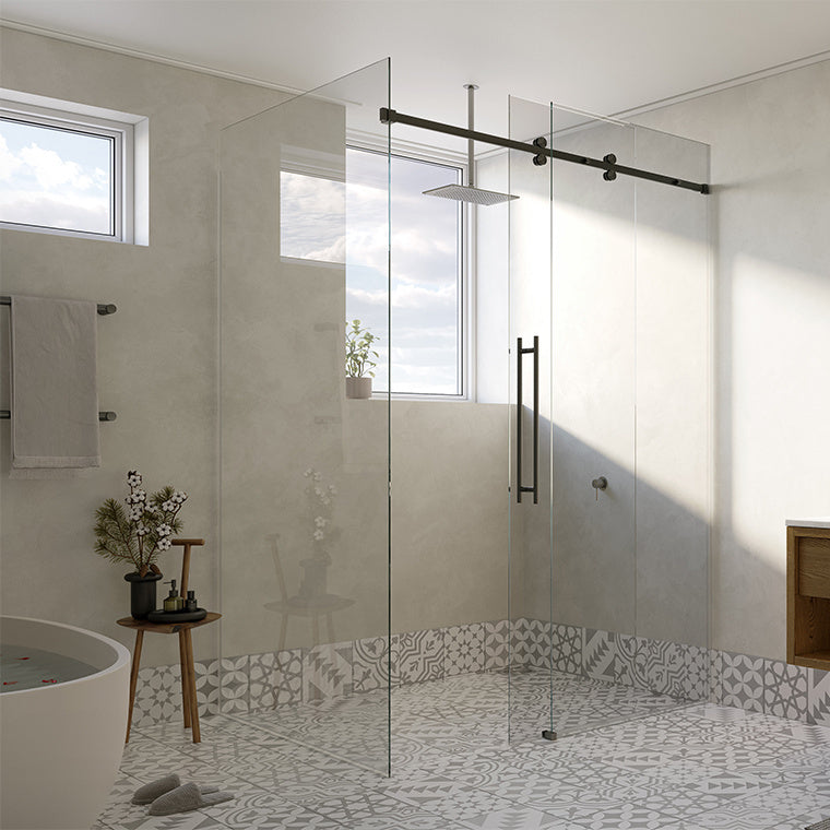 A close-up view of the matte black Cavoli sliding shower system installed in a modern bathroom with patterned tile flooring.