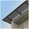 A low-angle view of a CRL Custom 7750 Series Sunshade featuring a perforated metal panel mounted to a building facade.