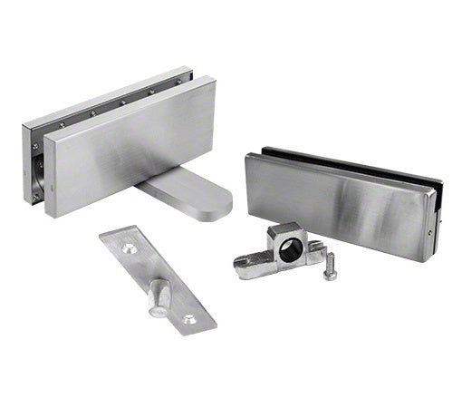 A set of brushed stainless steel hydraulic patch door hardware components including a patch fitting, pivot, and mounting hardware.