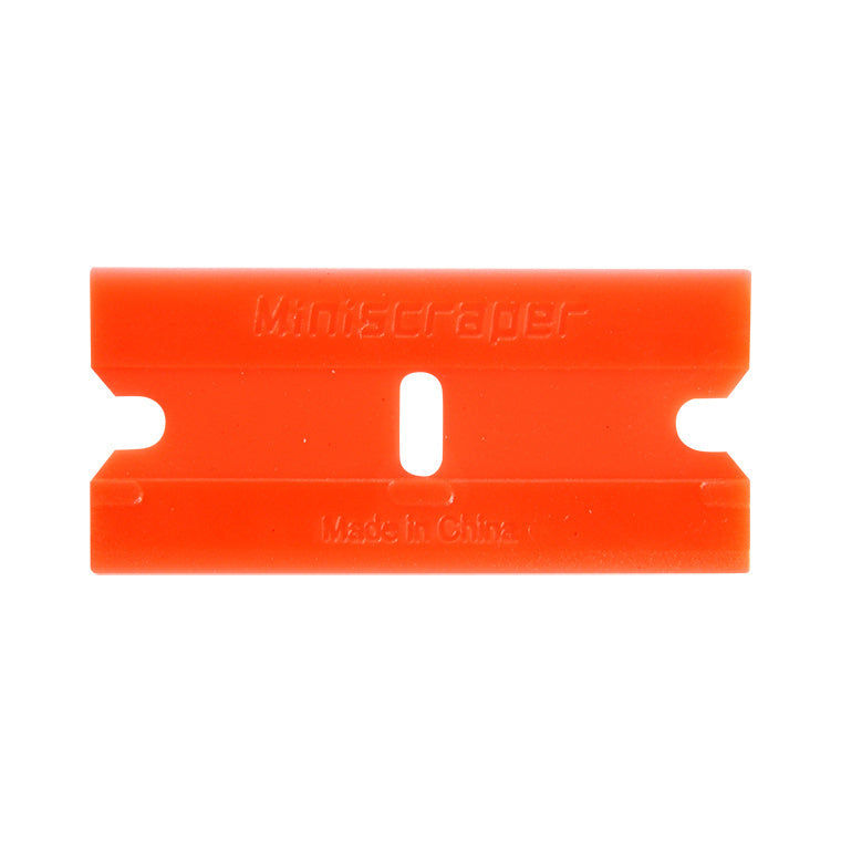 A single orange plastic double edge razor blade is shown against a white background.