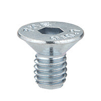 A close-up view of a silver-colored metal flat-head hex drive insert fastener for sliding door tracks.