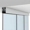 A side view showing the satin anodized ceiling mount track system installed above glass door panels.