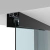 A close-up view of the matte black ceiling-mounted track system for a telescoping glass door.