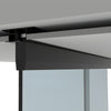 A close-up view of the matte black top-hung sliding door track mounted to a dropped ceiling.