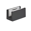 A matte black sliding door bottom guide featuring white plastic inserts.