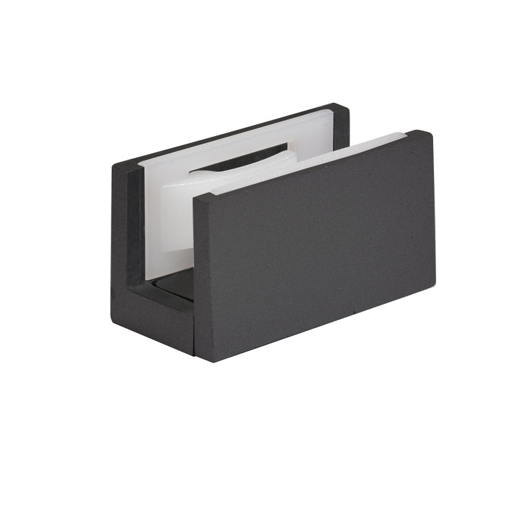 A matte black sliding door bottom guide featuring white plastic inserts.