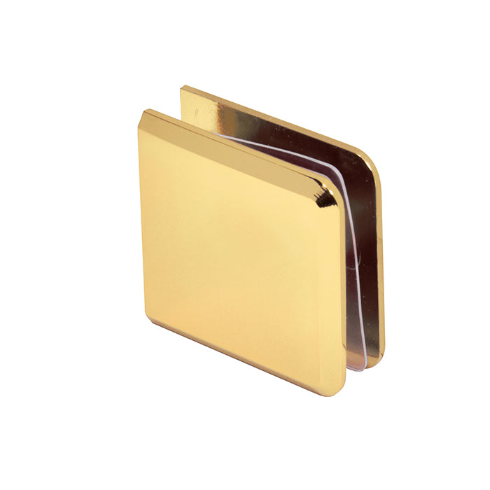 A polished brass beveled glass clamp shown from an angled perspective.