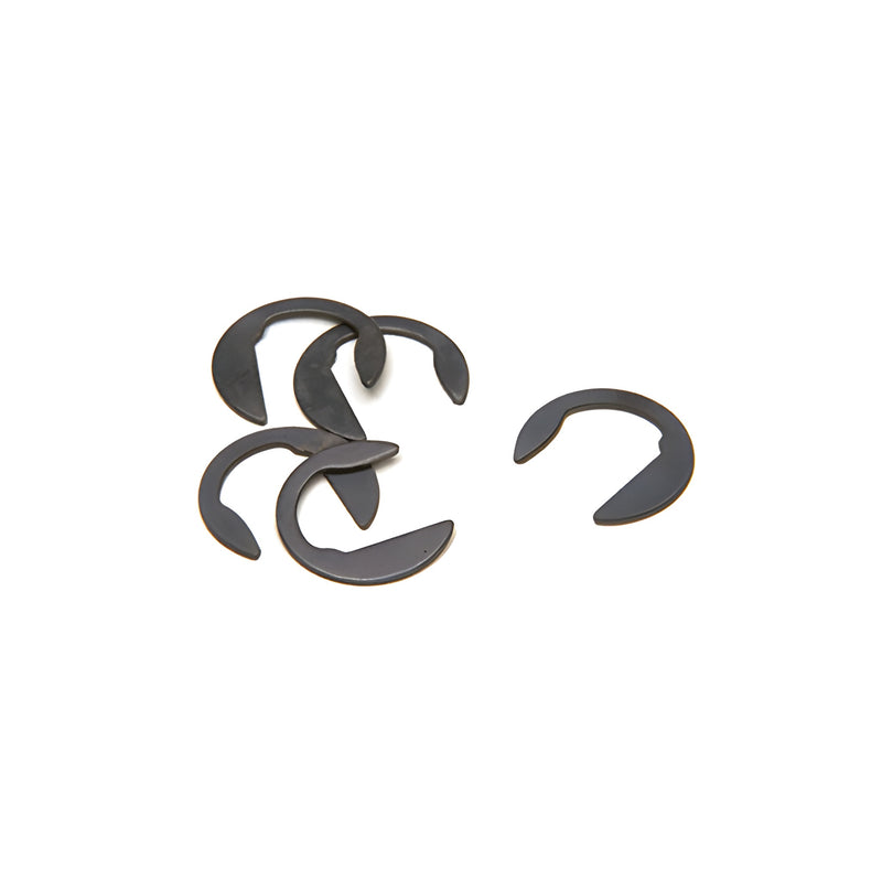 A group of five dark metal C-shaped offset arm shims are arranged on a white background.