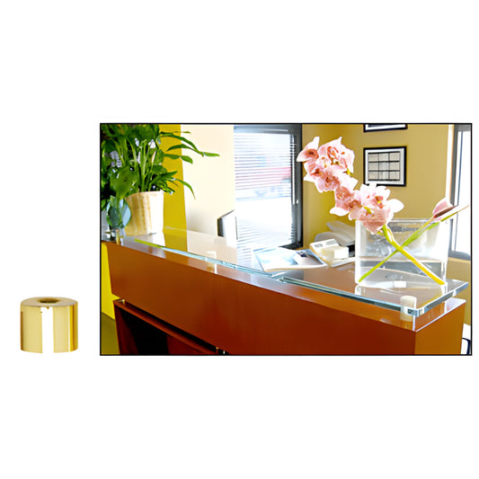 Polished brass 3/4" standoff cap beside glass-topped reception counter with pink orchid display
