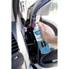 A hand uses the red straw attachment on a CRL Metal Lube can to apply lubricant to a car door hinge.