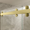 Close-up view of the satin brass top roller hardware on a Cambridge Series sliding shower door system.