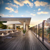 A modern outdoor deck featuring a glass railing system installed with matte black Cielo end posts.
