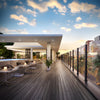 A modern outdoor deck featuring a glass railing system supported by black Cielo end posts.