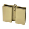 A close-up view of the Como Series glass-to-glass hinge in brushed bronze showing the concealed mounting design.