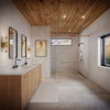 A modern bathroom interior showing the installed satin brass Brixen sliding shower door system in a niche configuration.