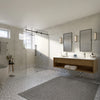 A wide-angle view of a modern bathroom featuring the Cavoli sliding shower system, a double vanity, and a freestanding tub.
