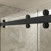 Close-up view of the matte black top roller hardware on the Cambridge Series sliding shower door system.
