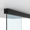 A matte black sliding door track mounted to a ceiling with a glass panel installed.