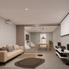 A modern interior room featuring a two-panel telescoping glass door system installed with a ceiling mount.