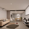 A modern living room featuring a matte black telescoping glass partition wall with right-stacking panels.