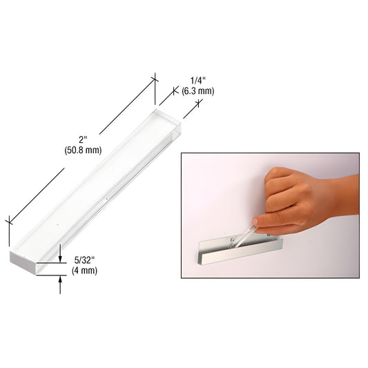 PSB156 clear plastic glass setting block, 2" x 1/4" x 5/32", shown in use in J-channel with hand.