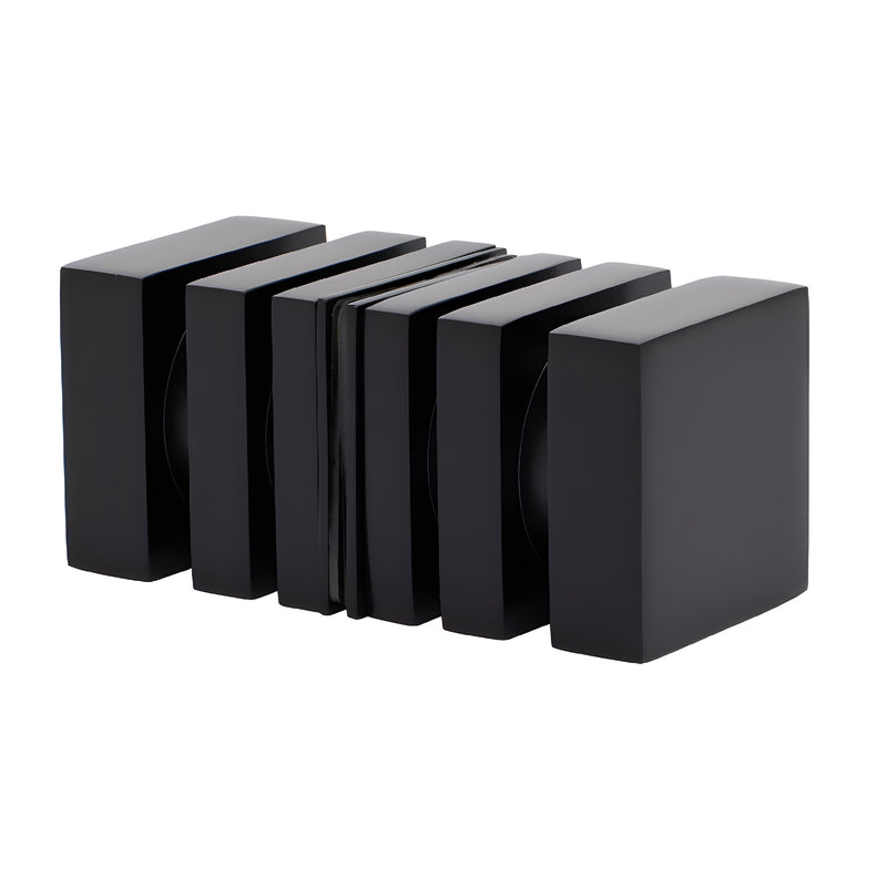 A pair of matte black square back-to-back shower door knobs shown from an angled perspective.