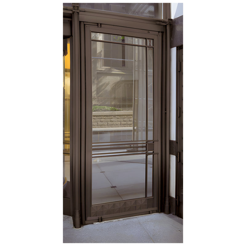 A dark bronze anodized aluminum medium stile door with 1-inch glazing and a 9-1/2 inch bottom rail installed in a storefront.