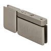 An angled view of the brushed nickel Prima pivot hinge showing the attached U-clamp and beveled edge profile.
