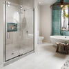 A modern bathroom features the CRL Crescent Series sliding glass shower door system with polished stainless steel hardware.