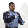 A worker wearing blue denim protective sleeves while safely handling a large sheet of glass.