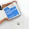 Hands holding a box of CRL Lint-Free Glass Wipes near the wall-mounted dispenser bracket.