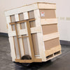 A CRL Split Case Dolly supporting a large wooden crate for easy transport of heavy building materials.