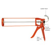 An orange CRL metal strap frame caulking gun with labels pointing to the ladder hook, thumb pressure release, and seal piercing tool.