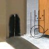 A black dust pad installed at the base of a door jamb to seal the gap against the floor.