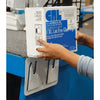 A person aligning a box of lint-free glass wipes onto the mounted dispenser bracket.