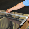 A close-up view shows a hand adjusting the measurement guide on the aluminum production speed cutter.