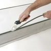 A person using the CRL backer rod tool to press a backer rod into a joint.