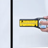 MG1500 handheld CRL glass thickness laser gauge with yellow fractional-inch scale and power button.