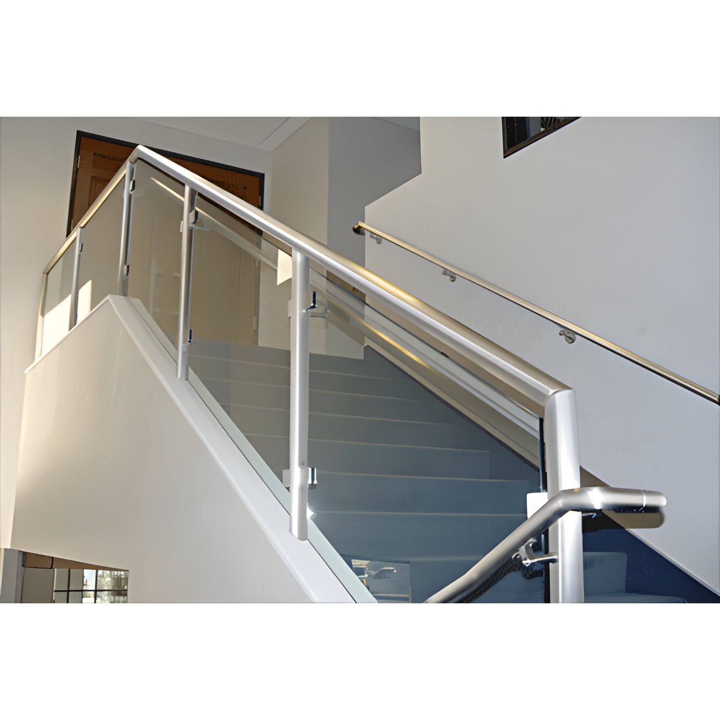 Polished stainless steel welded post railing PR1540PS with glass panels on interior stair, square posts and handrail