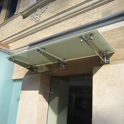 Stainless steel CRL Universal Curve wall-mount glass awning bracket (SKU GABCBS) with four glass attachment studs.