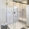 HYDK600RB 60" Hydroslide oil-rubbed bronze frameless sliding shower door with squared glass panels, marble tile interior